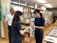 <学校図書館司書に納品している様子> <学校図書館司書に納品している様子>